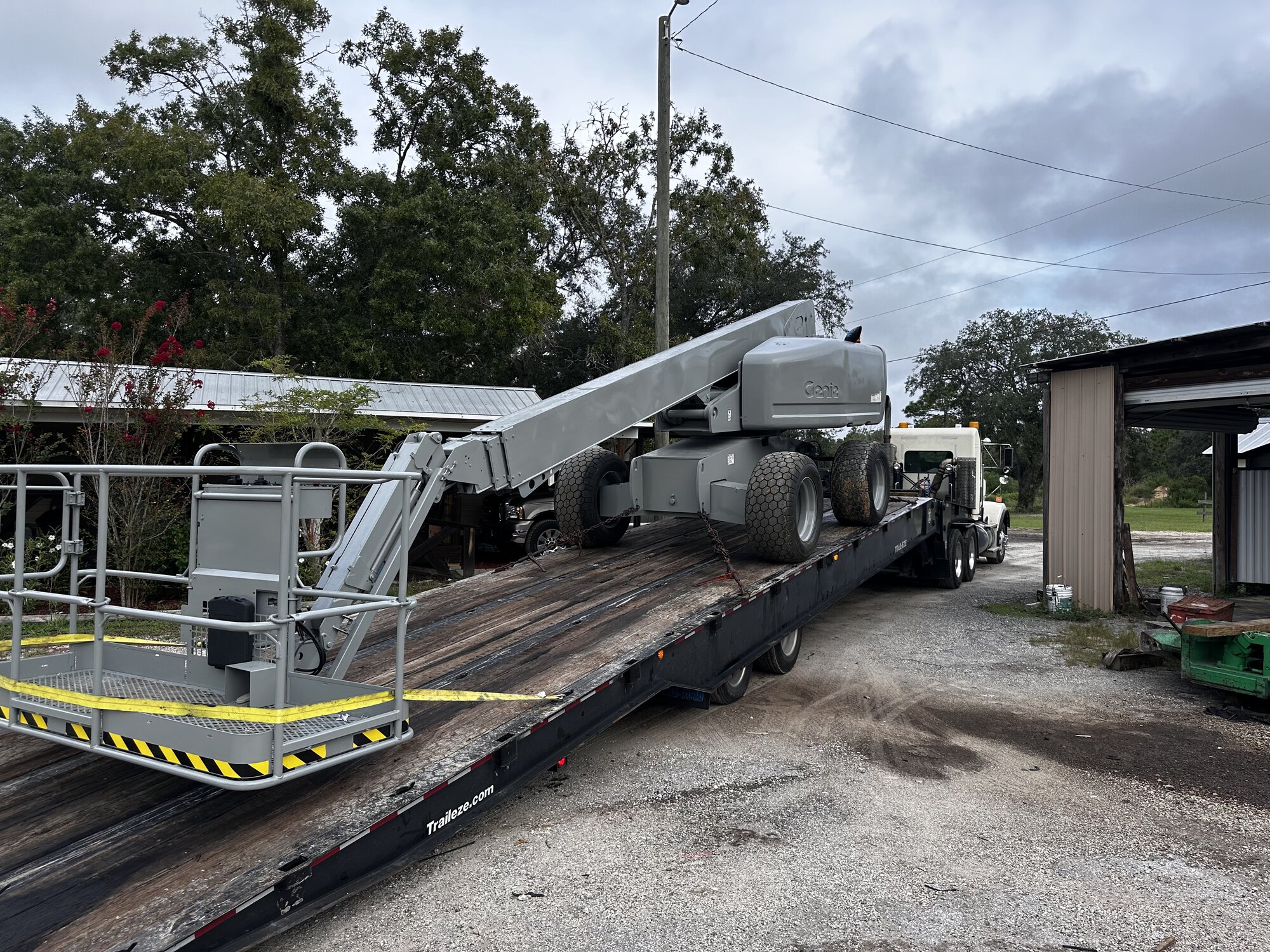 Boom lift staged for delivery on trailer