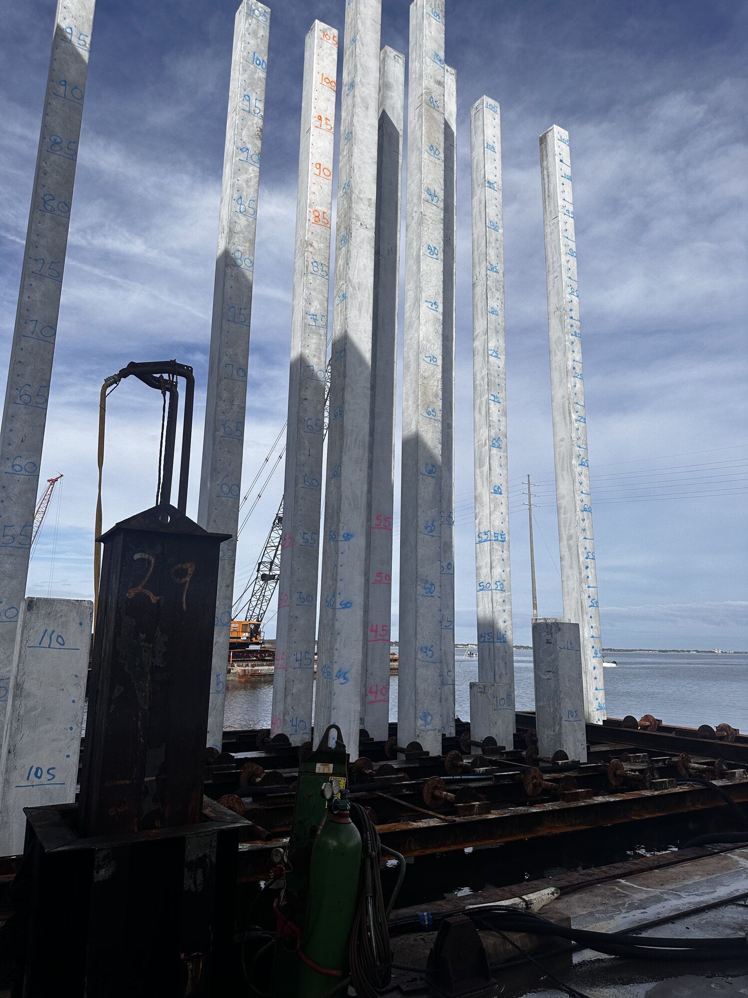 Concrete piles staged for installation
