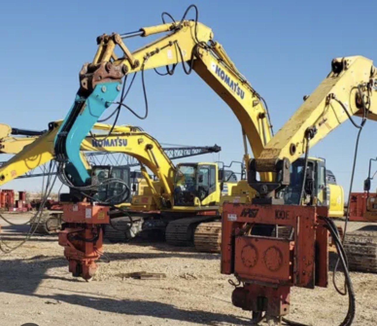Excavator mounted vibratory hammers on Komatsu excavators, supplied by J&G Sales